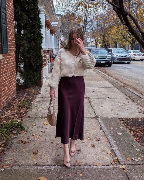 A touch of burgundy 🥀🍷 Outfit details linked in my stories or you can comment 'outfit details ' for links sent to your DM ✨ . . . . . #streetstylelook#burgundy#autumnstyle#explorepage#fyp#discover#explore burgundy outfits, cream and burgundy, classy outfits, fall outfits, winter fashion, OOTD, skirt fashion, skirt styling, styling tips, ways to style, how to style, wearing, bow heels, holiday heels, Christmas shoes, Christmas outfits, holiday party, modest outfits, knit cardigan, oversized... Burgundy And Cream Outfit, Modest Holiday Outfits, Classy Outfits Fall, Satin Skirt Outfit Winter, Burgundy Outfits, Skirt Styling, Holiday Heels, Satin Skirt Outfit, Cream Outfit