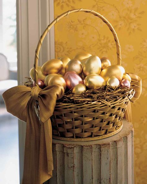 Easter Basket Ideas | Martha Stewart - Create an Easter basket display that resembles a pot of gold at the end of the rainbow. Metallic eggs, covered in varying shades of gold leaf sheets, were set atop a bed of spray-painted hay in a sponge-painted basket. For an elegant finishing touch, tie metallic vintage-ribbon bows on either side of the basket. Golden Egg Easter, Golden Egg, Easter Parade, Easter Basket Diy, Easter Inspiration, Shelby Gt500, Spring Holidays, Easter Time, Easter Egg Decorating