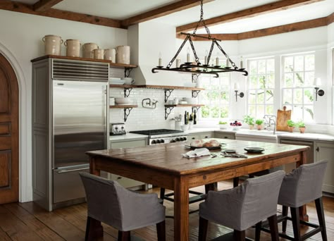 Not All Kitchens Have Islands — The Resurgence of the Center Table. Barbara Westbrook. Classic kitchen with taupe cabinets, marble counters, and rustic beams. Casa Cook, Kitchen Island With Seating, Farmhouse Kitchen Design, Island With Seating, Grey Kitchens, Farmhouse Style Kitchen, Trendy Kitchen, Eat In Kitchen, Dream Kitchen