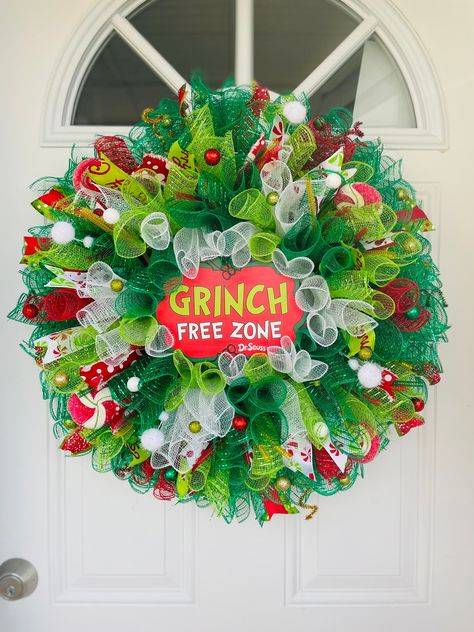 "Keep the Christmas spirit alive with the Grinch Free Zone mesh wreath! Adorned with an adorable sign, ribbons and glittery accessories! Perfect for any door wall or window. LED Green lights optional! Battery operated. Batteries not included. Ribbon styles may vary Measures 24\" across" Holiday Mesh Wreaths, Grinch Whoville, Mesh Christmas Wreath, Grinch Wreath, Grinch Decorations, Grinch Christmas Party, Christmas Mesh Wreath, Grinch Christmas Decorations, Mesh Wreath Diy