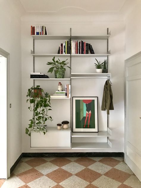 The 606 Universal Shelving System is sympathetic to your home. In this Milanese hallway it does not obstruct the floor or disturb the cornice. Note the hanging rail for coats by the door. Thank you for sharing your new system with us, Paulo. Start planning – free of charge – at vitsoe.com/planning Vitsoe 606, Hallway Shelving, Dieter Rams Design, Custom Shelving, Dieter Rams, Hallway Storage, Modular Shelving, Understairs Storage, Shelving Systems