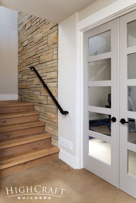 Modern-Basement-Remodel-Five-Panel-Glass-Doors-Gym-Stone-Stairwell-Wall Basement Wall Panels, Door Gym, Stairwell Wall, Modern Basement, Basement Bar Designs, Bar Designs, Basement Walls, Basement Remodel, Basement Bar