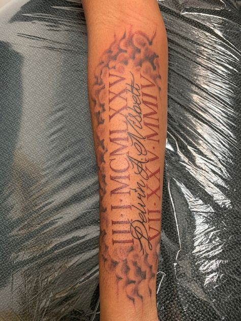 Tattoo remembering your father’s death Roman Numbers Tattoo Forearm, Roman Numerals Memorial Tattoo, Tattoo Designs Men Roman Numerals, Two Roman Numeral Tattoos, Name With Roman Numeral Tattoo, Roman Numeral Tattoo Men Arm Half Sleeves, Roman Numeral Memorial Tattoo, Roman Numeral Tattoo Men Forearm, Tattoo Ideas For Dark Skin