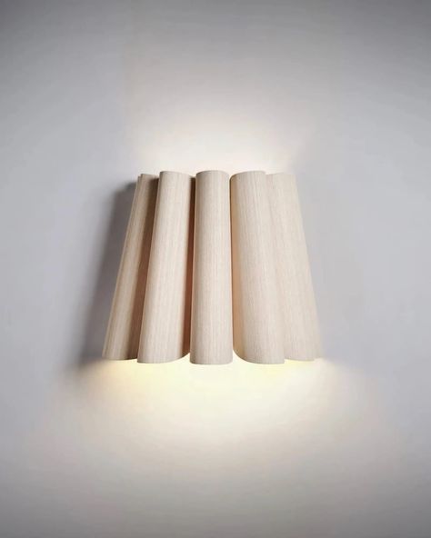 The Renata Wall Light, a striking combination of bold character and exquisite design. Crafted with curved veneer in a range of finishes, this wall light emanates a contemporary charm that seamlessly brings nature into your living spaces. The unique design allows for indirect light projection both upwards and downwards, creating a soft wash of light that fosters a relaxed and inviting atmosphere. The Renata Wall Light features a bold character and contemporary design. Crafted with curved veneer i