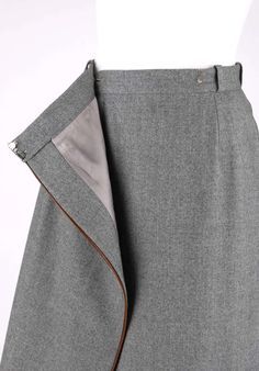 For Sale on 1stDibs - Vintage Gucci c.1970's gray wool wrap skirt. Four belt loops. Brown leather piping detail. Front wrap design with hook and bar and single button closures. Wool Skirt Pattern, Chic Skirt Outfits, Feminine Streetwear, Wool Wrap Skirt, Sewing Shorts, Unique Skirts, Business Skirt, Classic Skirts, Fashion Vocabulary