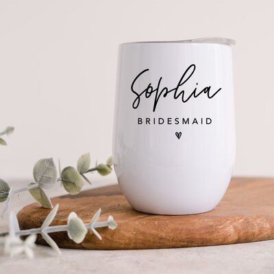 Pour the wine, champagne, cocktails, or any of your favorite beverages and keep it safe in this 12 oz tumbler. Perfect for bridal or wedding shower gifts, choose from hundreds of designs to personalize for the bride, bridesmaids, flower girl, or even the mother of the bride | Koyal Wholesale Custom Bridesmaid Wine Tumbler w/ Lid 12 Oz Stemless Stainless Steel Insulated in White, Size 4.3 H x 3.5 W in | Wayfair Bridesmaid Wine Tumbler, Bridesmaid Cup Ideas, Bridesmaid Tumblers, Bride Cup, Bridesmaid Cups, 12 Oz Tumbler, Bride Tumbler, Champagne Cocktails, Bridesmaid Wine