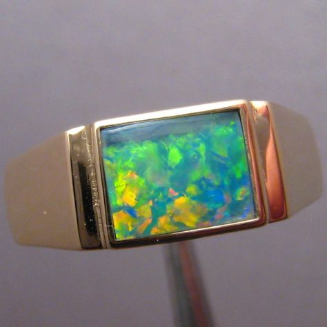 A quality opal gold ring for men with a vibrant and lively inlaid Australian opal.  The ring is crafted in 14k gold and has a smooth high polish allowing all focus on the quality Coober Pedy gem. Opal Rings For Men, Mens Opal Jewelry, Mens Gold Opal Ring, Fire Opal Ring Men, Opal Mens Ring, Gold Ring For Men, Opal Gold Ring, Opal Bangle, Opal Wedding Band