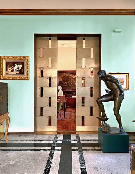 Veranda, looking into Library thru Portaluppi-designed German silver pocket doors | Villa Necchi Campiglio | Milan | Adolfo Wildt's 1930 sculpture "The Fool" - depicting Parsifal battling evil, which is represented by snake crushed under Holy Grail chalice | Architect Piero Portaluppi (1932-1935) | Photo credit: Jesus Cano for AD Espana, April 30, 2022 Bungalow On The Beach, Villa Necchi Campiglio, Villa Necchi, Arabescato Marble, Floor Pattern, Walnut Floors, Dining Room Ceiling, House Museum, Floor Patterns