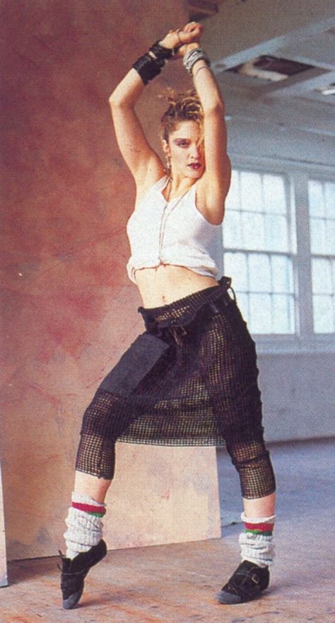 Madonna in her dance inspired outfit complete with netted skirt, leg warmers, half shirt, stacks of bracelets, and jazz shoes. 80s Leg Warmers, Madonna Young, Madonna Fashion, Madonna Looks, Madonna Pictures, Madonna 80s, Madonna Photos, 80’s Fashion, Mazzy Star