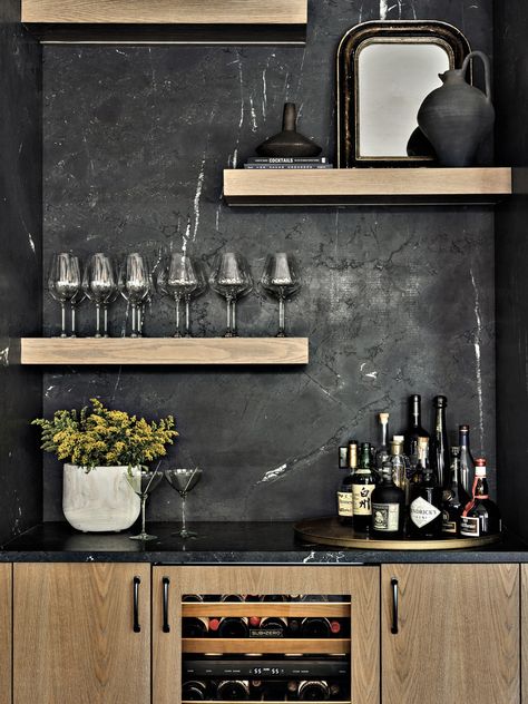 Off the kitchen and across from the dining area, a bar features Negresco granite from Serrano’s Marble & Granite in a leathered finish. The white oak cabinetry and floating shelves are the work of Modern Kitchen Center. The wine refrigerator is Sub-Zero. Negresco Granite, Rh Dining, Modern Oak Kitchen, Contemporary Mountain Home, Leather Granite, Modern Home Bar, Modern Basement, Luxury Bar, Fun House