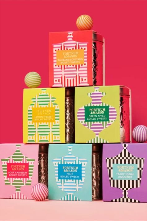 Together Design's packaging for Fortnum & Mason's pick-up gift range of sweets draws inspiration from the 18th-century sweets counter in the department store. The packaging showcases an array of vintage sweet jar shapes decorated with cheerful patterns and colors, paying homage to the timeless sweets category. Packaging With Pattern, Xmas Packaging Design, Cpg Packaging Design, Valentine Packaging Design Boxes, Colorful Packaging Design, Vintage Packaging Design, Jar Shapes, Holiday Packaging Design, Dessert Package