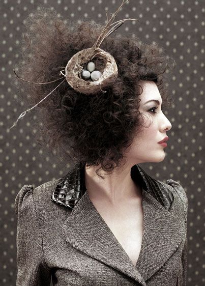 Celeste Thorson with a bird nest in her hair with 3 eggs wearing an office grey dress with great make up and smokey eyes. Cosmetology Ideas, Which Makeup, Whimsical Hair, Homeless Shelters, Unusual Hats, Avant Garde Hair, Festival Attire, Headpiece Diy, Makeup Photo