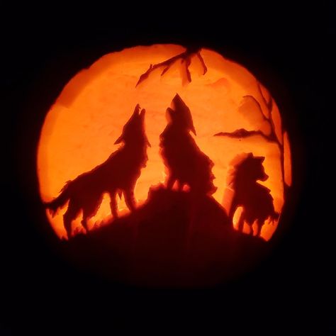 Pumpkin carving depicting three wolves howling up at the moon. Tree branch silhouettes in the foreground. Wolf Howling, Scary Movies, Pumpkin Carving, Carving, Halloween