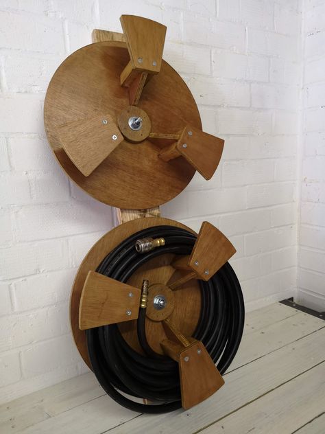 Air Hose Storage Reels Air Hose Storage Ideas, Hosepipe Storage Ideas, Air Hose Reel Diy, Diy Hose Reel, Compressor Hose Reel Diy, Tire Rim Hose Holder, Air Compressor Hose Reel, Hime Made Water Hose Hanger, Air Hose Reel