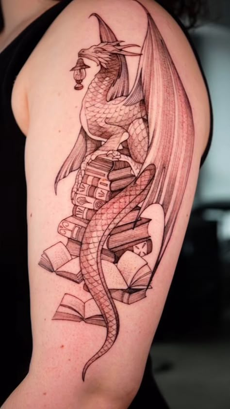 Dragon And Book Tattoo Ideas, Dragon Books Tattoo, Book Dragon Tattoo For Women, Inkheart Tattoos, Dragon On Books Tattoo, Bookish Dragon Tattoo, Dragon And Books Tattoo, Dragon With Books Tattoo, Book Dragon Tattoo Ideas