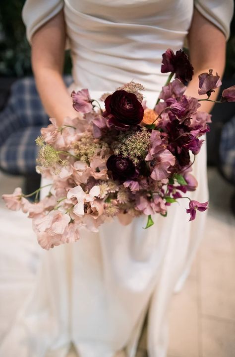 REAL WEDDING: Cassie + Ryan, The Alcove, OTR, Cincinnati – Eve Floral Co. A modern and romantic New Year's Eve wedding in Cincinnati, Ohio. Wedding planner: Block Party Event Co. Florist: Eve Floral Co. Photographer: Bri Nicole Location: Alcove by Madtree Sweet pea bridal bouquet with black velvet ribbon Bridal Bouquet Moody, Mauve And Black Wedding, January Bouquet, Bridal Bouquet With Black, Sweet Pea Bridal Bouquet, Sweet Pea Wedding Bouquet, Unique Wedding Bouquet Ideas, Asymmetrical Bouquet, Aubergine Wedding