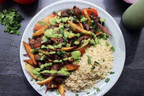 El Pollo Inka's most popular entree, Lomo Saltado, is sliced steak, onions, tomatoes, fries and cilantro topped with spicy green aji sauce and brown rice. Lomo Saltado Recipe, Aji Sauce, Garlic Brown Sugar Chicken, Slow Cooker Bacon, Peruvian Dishes, Dinner Then Dessert, Lomo Saltado, Peruvian Recipes, Brown Rice