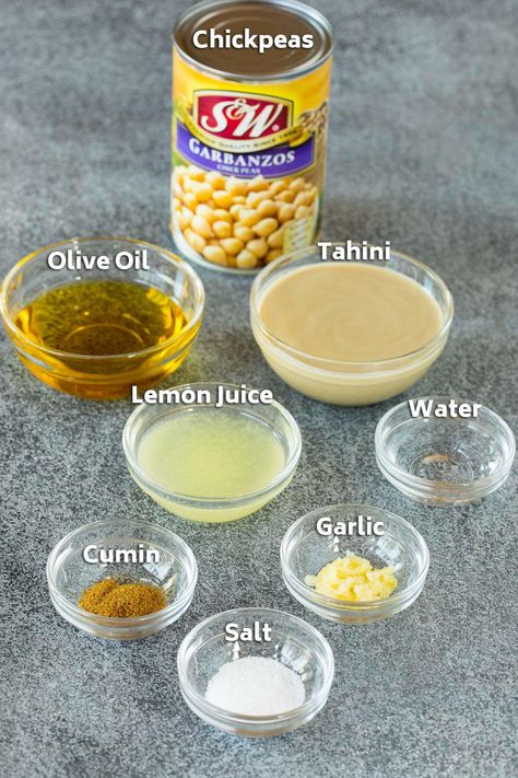 Ingredients including a can of chickpeas, and bowls filled with lemon juice, tahini, olive oil and spices. How To Make Hummus From Canned Chickpeas, The Best Hummus, Best Hummus Recipe, Best Hummus, Lemon Juice Water, Storing Lemons, Hummus Recipes, Hummus Ingredients, Hummus Recipe Homemade