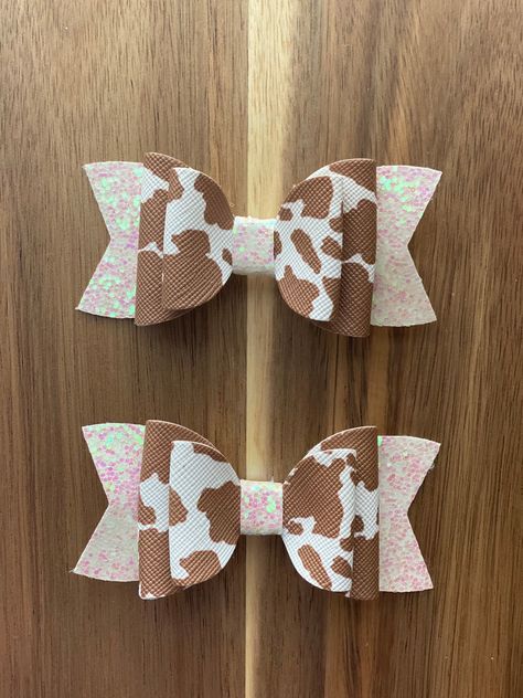 "3\" Faux Leather Hair Bow Clip Cow Print These faux leather hair bows are the perfect accessory.  Each bow is made from high quality printed faux leather material and attached to an alligator clip to stay secure in hair all day long.  This is for ONE single bow, for a pigtail set you will need to buy two. If you have any questions please feel free to send me a message and I will get back to you asap." Faux Leather Hair Bows Diy, Faux Leather Hair Bows, Spring Bows, Leather Hair Bows, Faux Leather Bows, Woman Costumes, Hair Bow Clip, Handmade Hair Bows, Bow Clip