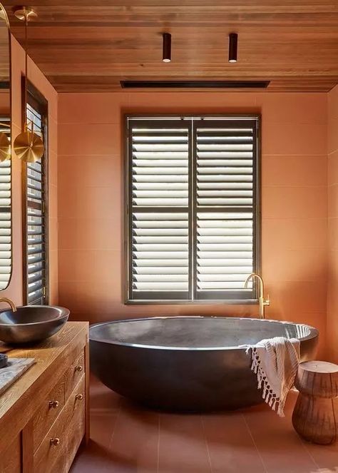 an earthy tone bathroom with burnt orange tiles and terracotta on the floor, a stained vanity, sinks and an oval tub Burnt Orange Bathroom, Neutral Boho Living Room, Eclectic Bedding, Terracotta Walls, Bold Bedding, Dark Green Living Room, Small Gallery Wall, Bold Bedroom, Orange Bathroom