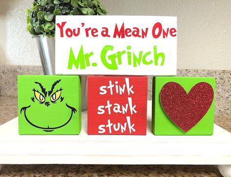 Grinch Mini Wooden Blocks Tiered Tray Decor !!PLEASE READ!!  *You're a Mean One- 5"x2.5" *Grinch, Stink, Heart- 2.5" x 2.5" Materials used: *Red Vinyl, White Vinyl, Neon Green Vinyl, Red Glitter Cardstock, Acrylic Paint  THIS listing is for 4 adorable wooden blocks: great fillers to add to your tiered trays, coffee bars, shelves, hutch, kitchen counter... the possibilities are endless. These blocks are self-standing so they are easy to place anywhere!   ALL wooden blocks are hand made by ME! Please keep in mind, wood blocks may have knots, cracks, dents or imperfections, that make each piece unique.  If you are looking for a "perfect" block of wood, please reconsider making this purchase.  *Christmas Decor *Grinch *Grinch Christmas *Whoville Christmas *Dr. Seuss *Cindy Lou Who *Christmas 2 Whoville Decor, Grinchmas Decorations Diy, Wood Signs Christmas, Grinch Christmas Decor, Diy Christmas Crafts To Sell, Christmas Bazaar Crafts, Grinch Crafts, Christmas Decor Farmhouse, Grinch Decorations