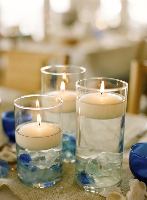 Floating candles and sea glass part of the table designs at the rehearsal dinner at The Beach Club, Centerville Beach Glass Centerpieces, Sea Glass Wedding Table Decor, Beach Reception Ideas Table Decorations, Sea Glass Centerpiece, Sea Glass Centerpiece Wedding, Sea Glass Table Decor, Sea Glass Wedding Centerpieces, Seaglass Wedding Centerpieces, Seaglass Centerpiece