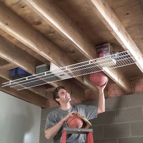 #organizer #organization #storageideas #storage Overhead Garage Storage, Fishing Rod Storage, Overhead Garage, Shed Organization, The Family Handyman, Basement Storage, Garage Storage Organization, How To Hang, Family Handyman