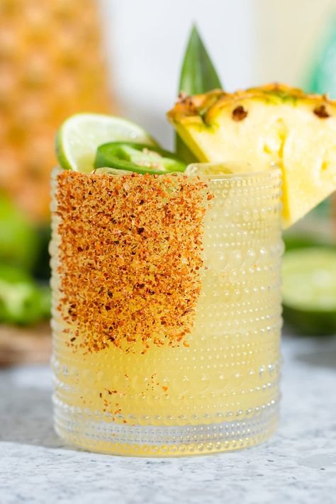 This Pineapple Jalapeno Margarita is the perfect combination of sweet and spicy and a great summer cocktail! Made with pineapple juice and fresh jalapenos, this drink is easy to make and a fun twist on the classic margarita we all know and love! The cocktail is also really easy to turn into a mocktail so everyone can enjoy it! Pineapple Mezcal Margarita, Pineapple Jalapeno Margarita, Margarita Mocktail, Clothing Painting, Tropical Drink Recipes, Cocktails Summer, Mezcal Margarita, Pineapple Margarita, Jalapeno Margarita