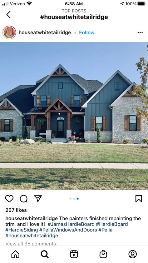 Rustic Blue House Exterior, Navy House With Wood Accents, Blue House Exterior Black Windows, Green Siding House With Stone, Midnight Blue Vinyl Siding House, Blue House With Stone Accent, Navy Blue House Exterior With Stone, Teal Siding Exterior, Blue Sided House