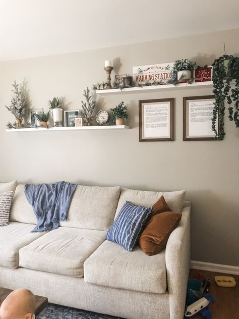 Adding some Christmas touches to my living room shelves. Perfect above the couch decorations to keep away from the babies! Decor Over Couch, Shelves Above Couch, Decor Above Couch, Above Couch Decor, Couch Wall Decor, Wall Shelves Living Room, Sofa Wall Decor, Shelf Decor Living Room, Family Room Walls