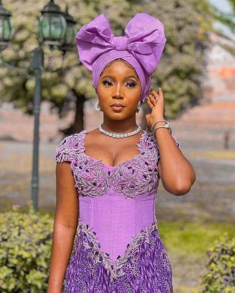 Latest, Mind-blowing Asoebi styles that would blow your mind Lilac Lace Gown Styles Aso Ebi, Lilac Lace Asoebi Styles, Latest Lace Gown Styles Aso Ebi, Robe Dote, Corset Asoebi Styles, Ankara Asoebi Styles, Lace Gown Styles Aso Ebi, Owanbe Styles, Ankara Asoebi