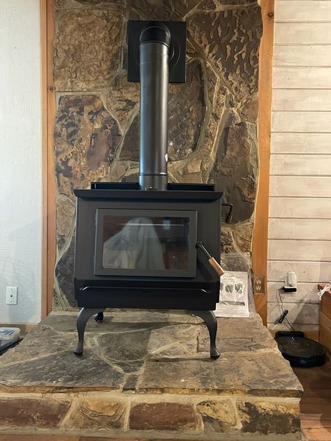 Here is another install we have done, a Blaze King stove on a stone hearth. Contact us today for pricing and customization options. Brick Fireplace With Stone Hearth, Wood Burning Stove Rock Wall, Rock Wall Behind Wood Stove, Stone Hearths, Sauna Trailer, Chimney Ideas, Perth House, Stove Hearth, Wood Stove Hearth