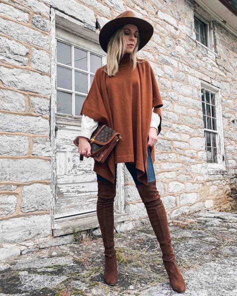 Meagan Brandon fashion blogger of Meagan's Moda shows chic ways to wear a poncho, rust orange sweater with over the knee boots How To Wear Ponchos Outfits Fall, Oversized Open Knit Poncho For Fall, Knit Poncho For Fall Layering, Sweater Poncho Outfit, Fall Layering Shawl Poncho, Cozy Brown Poncho For Layering, Poncho Outfit Fall, How To Style A Poncho, Fall Poncho