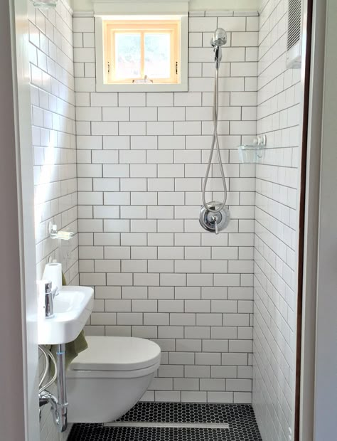 tiny bathroom, wall hung toilet and sink, subway tile, black hex floor tile, strip drain, compact modern bathroom Bathroom Wet Wall, Wet Bathroom Ideas, Tiny House Shower, Tiny Shower Room, Tiny Wet Room, Small Narrow Bathroom, Small Wet Room, Wet Bathroom, Small Shower Room