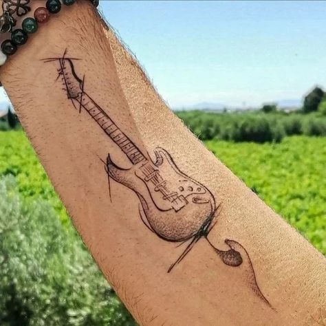 50 Most Demanding Hand Tattoo Ideas For Men. - TiptopGents Guitar Tattoo For Men, For Hand Tattoo, Hand Tattoo Ideas For Men, Music Guitar Tattoo, Green Day Tattoo, Tattoo Guitar, Hand Tattoo Design, Music Lover Tattoo, Musician Tattoo