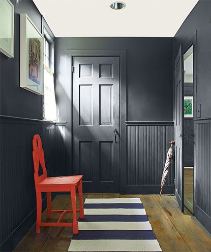 Red chair in a mudroom with walls painted in Soot 2129-20. Benjamin Moore Soot Accent Wall, Soot Benjamin Moore, Black Beadboard, Pine Paneling, Decorative Wall Molding, Black Painted Walls, Painted Wainscoting, Most Popular Paint Colors, Palettes Color