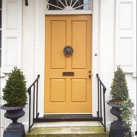 Mustard Yellow | One of our favorite aspects of the Holy City is the array of gorgeous street front doors—arguably the most charming of their kind in the South. Here, readers share Instagram snaps of beautiful Charleston doors. Share your photos with us by tagging @southernlivingmag or using #southernliving for a chance to be featured on SouthernLiving.com. Mustard Yellow Front Door, Orange Front Door, Yellow Front Door, Orange Front Doors, Exterior Door Colors, Yellow Front Doors, Sweden House, Front Door Paint Colors, Door Paint Colors