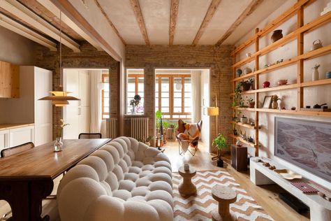 "The kitchen was relocated to benefit from natural light, and the overall layout was adjusted to create a more open and connected living space," Bernat writes.  Credit: <a href="https://www.apartmenttherapy.com/authors/lula-poggi-2">Lula Poggi</a> Open Concept Living Room Layout, Faux Mirror, Room Couches, Barcelona Apartment, Open Concept Living Room, Bedroom Orange, Apartment Tour, Brown Furniture, Livingroom Layout