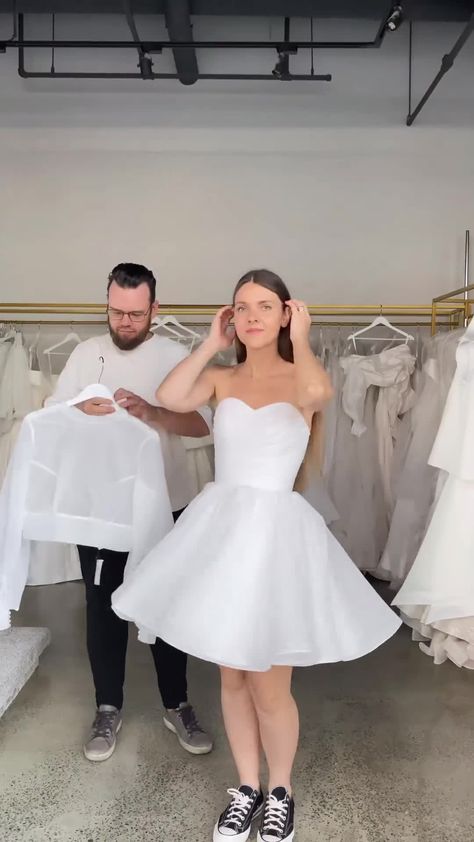 Step into a world of whimsical romance with our ethereal organza ensemble. Featuring a baby doll dress, high neck blouse, detachable skirt, this unique look will enchant hearts and leave a lasting impression. Detachable Skirt Dress, Detachable Dress, Wedding Skirt And Top, Wedding Dress Detachable Skirt Tulle, Mini Wedding Dress With Overskirt, White Organza Ball Gown With Detachable Train, White Organza Dress With Detachable Train, Baby Doll Dress, Wedding Mini Dress With Sheer Bodice Organza