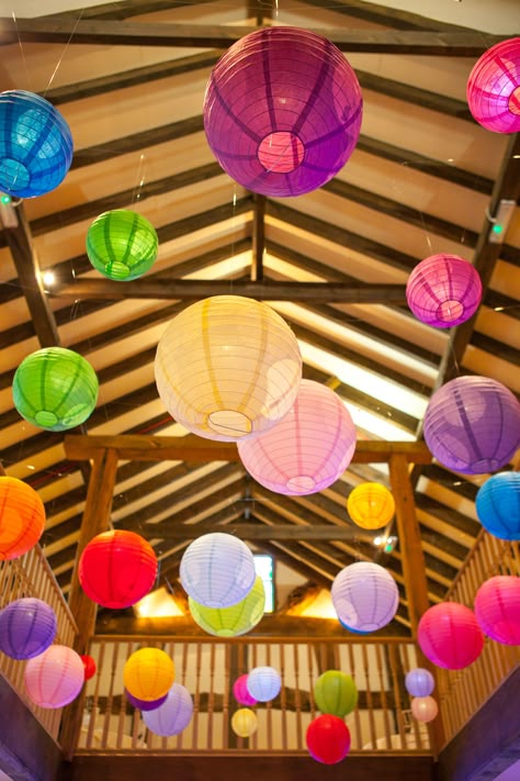 Bright coloured paper lanterns really enlighten this dark beamed venue, this bride picked all the colours of the rainbow! Very funky! Hanging Paper Lanterns Classroom, Colourful Decorations, Pride Decorations, Colour Festival, Marquee Decoration, Carnival Baby Showers, Cocktail Party Decor, Carnival Decorations, Hanging Paper Lanterns