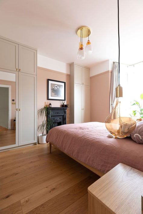 A stunning bedroom renovation in off peach walls, pink bedding and timber furniture, adding warmth to the main bedroom. The elegancy of the Tala pendants hanging either side of the bed for decorative + focal lighting adds to the character of the room. Read more about this project here! Do you need help with your London or Brighton renovation? Contact us now! Renovation by Absolute Project Management, photography by Moon Street Studio. #renovation #bedroom #interiordesign #aesthetic #art #pink Peach Bedroom Aesthetic, Aesthetic Art Pink, Complete House Renovation, Renovation Bedroom, Reclaimed Fireplace, Studio Renovation, Peach Bedroom, Bifold Patio Doors, Contemporary Design Style