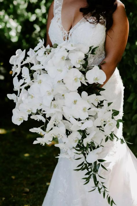 50 White Wedding Ideas & Decorations for a Monochromatic Vibe Most Popular Wedding Colors, White Orchid Bouquet, Orchid Bouquet Wedding, Wedding Bouquet Ideas, Popular Wedding Colors, Cascading Bridal Bouquets, Cascading Wedding Bouquets, Orchid Bouquet, All White Wedding