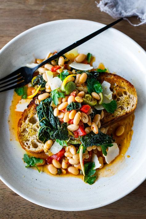 Brothy Beans over garlic-infused sourdough toast w/ lacinato kale, roasted peppers, olives, capers & lemon zest - an easy 30 minute meal! Brothy Beans, Beans And Greens, Lacinato Kale, Feasting At Home, Sourdough Toast, Garlic Toast, Crispy Garlic, 30 Minute Meals Easy, Healthy Vegetarian Dinner