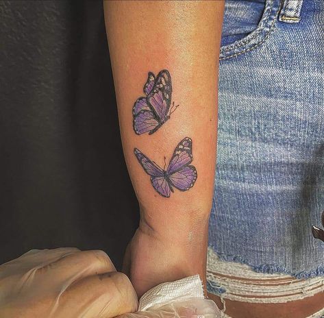 Purple Tattoos On Black Women, Purple Butterflies Tattoo, Purple Outline Tattoo, Lilac Butterfly Tattoo, Purple Butterfly Tattoos, Purple Tattoo On Dark Skin, Small Purple Butterfly Tattoo, Butterfly Tattoo On Dark Skin, Butterfly Tattoo Purple