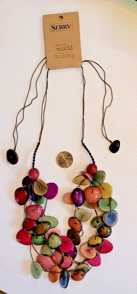 Tagua Necklace Fun and fair! Natural tagua is carved and dyed by artisans into beads for this 6-strand necklace, then strung on an adjustable cotton cord. Each cord ends in a tagua nut, as well. Color and shape may vary. Approximate fully extended length - 18". Your purchase helps rural artisans in Ecuador receive fair wages with access to international fair-trade markets. Since 1980, SERRV International has partnered with artisans in Ecuador, providing a long-term trading partnership and interest-free advance payment for our orders. Through sales of their products, more than 500 artisans and farmers in 18 of Ecuador's 24 provinces receive access to financing and business training in addition to preserving traditional crafting techniques. Tagua Necklace, Artisan Jewelry Necklaces, Diy Jewelry Findings, Tagua Nuts, Cord Ends, Handcrafted Artisan Jewelry, Crown Jewels, Multi Strand Necklace, Strand Necklace