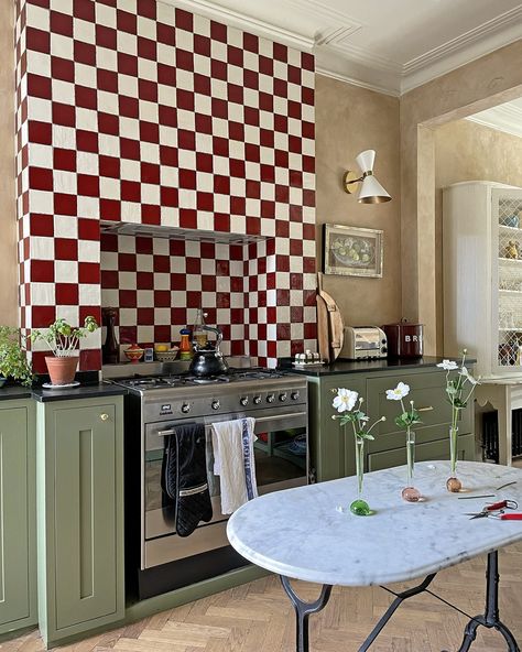 Check It Out - A bold tile can lead the kitchen color palette, and you can take it to the ceiling to really make an impact. In this kitchen, @matildagoad picked an eye-catching checkerboard tiling in oxblood and cream, paired with sage green cabinets and lime wash painted walls. . See more kitchen tile ideas at the link in bio. . #homesandgardens #kitchen #tile #checkerboard Lime Wash Kitchen Walls, Wash Painted Walls, Striped Backsplash, Alcove Bar, Red Green Kitchen, Fireplace Alcove, Kitchen Color Palette, Sage Green Cabinets, Kitchen Tile Ideas