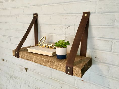 Rustic shelf with leather straps as brackets Leather Strap Bookshelf, Shelf With Leather Straps, Wood And Leather Shelf, Leather Strap Shelves Diy, Leather Shelf Brackets, Leather Shelf Strap, 50s Style Kitchens, Strap Shelves, Leather Shelf