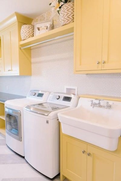 10 Reasons Why You Should Paint Your Laundry Room Yellow | Domino Light Yellow Laundry Room, Laundry Room With Utility Sink Ideas, Yellow Laundry Room, Shaker Laundry, Yellow Laundry, Unfinished Basement Laundry, Cabinet Wallpaper, Yellow Laundry Rooms, Cabinet Layout