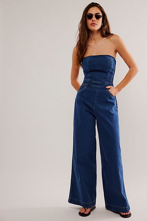 Forever timeless with a femme touch, this jumpsuit from Wrangler is the perfect done-in-one instant outfit. **Fit:** Slim, corset-inspired bodice with wide-leg fit **Features:** Strapless design, side zip closure, smocked back for ease, soft stretch denim **Why We ❤ It:** Sleek with fun platforms or off-duty with sporty sneakers, this pair has endless ways to wear. | Wrangler Corset Playsuit at Free People in Dark Wash, Size: M Jean Jumpsuit Outfit, Strapless Jumpsuit Outfit, Jean Jumpsuit, Playsuits Outfit, Sporty Sneakers, Jumpsuit Outfit, Strapless Jumpsuit, Embellished Jeans, Jumpsuit Fashion