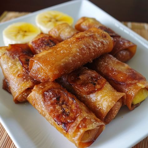 🍌 Satisfy your sweet tooth with this crispy and delicious Turon! 🍌 #Turon #FilipinoDessert Turon (Banana Lumpia) Ingredients: Ripe bananas (6, sliced lengthwise) Lumpia wrappers (12 pcs) Brown sugar (1 cup) Jackfruit (optional, sliced) Oil (for frying) Instructions: Place a slice of banana and jackfruit (if using) on a lumpia wrapper. Sprinkle with brown sugar. Roll tightly and seal the edges with water. Heat oil in a pan and fry Turon until golden brown. Drain on paper towels and serve h... Turon Banana, Turon Recipe, Banana Lumpia, Lumpia Wrapper, Instagram Recipes, Twisted Recipes, Filipino Desserts, Ripe Bananas, Trending Recipes